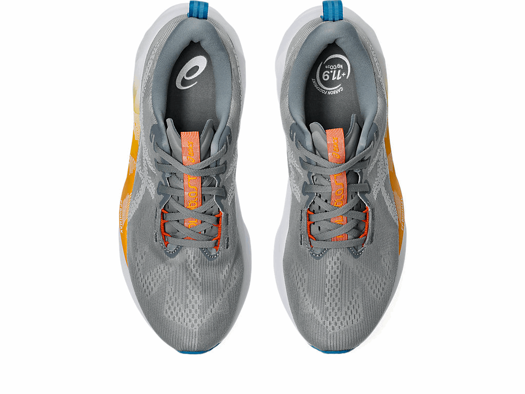 Gray men's ASICS Novablast 5 running shoe pair, orange lace eyelets, ASICS logo on tongue, padded collar.