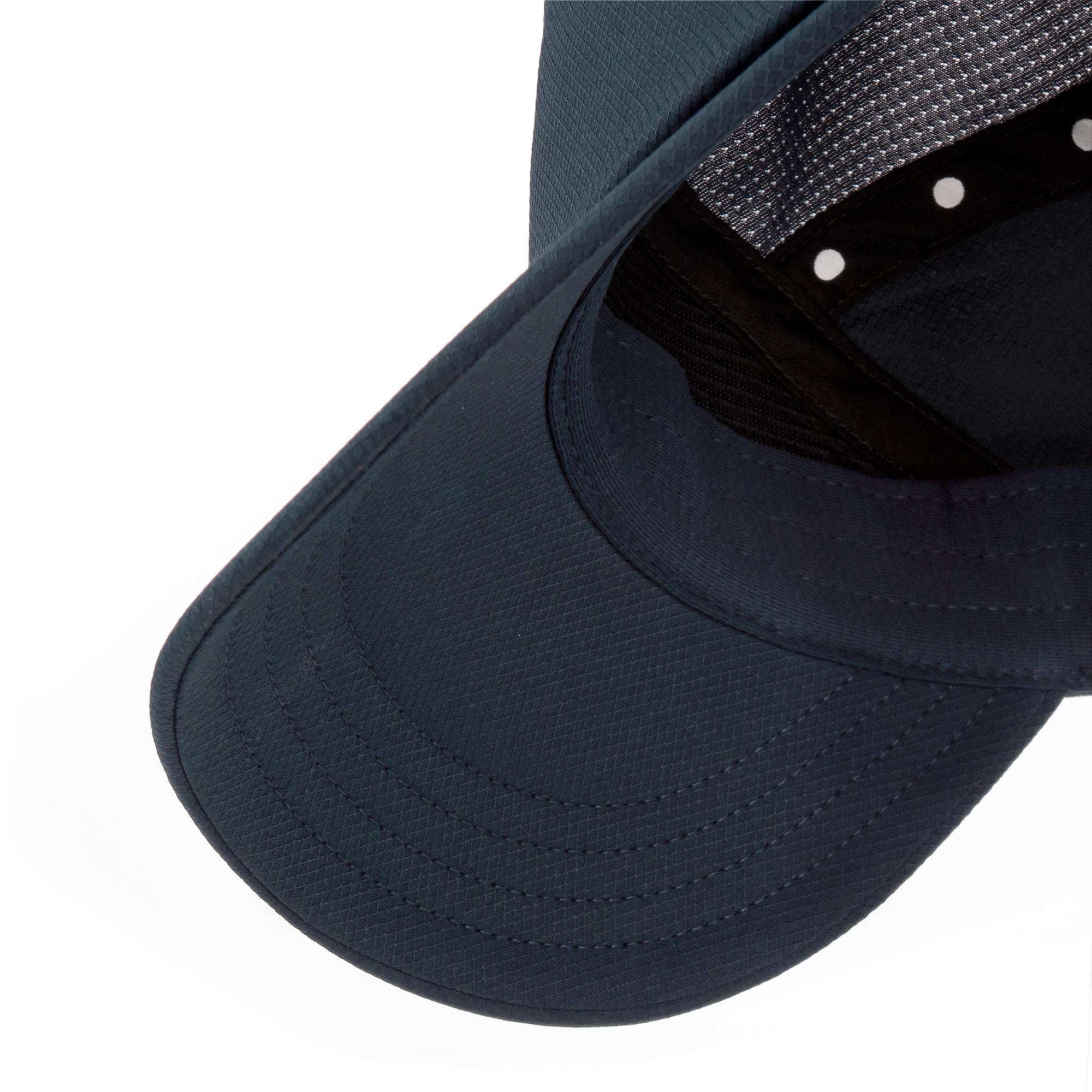Close-up of dark navy Ciele cap brim and interior mesh panel with snap adjuster