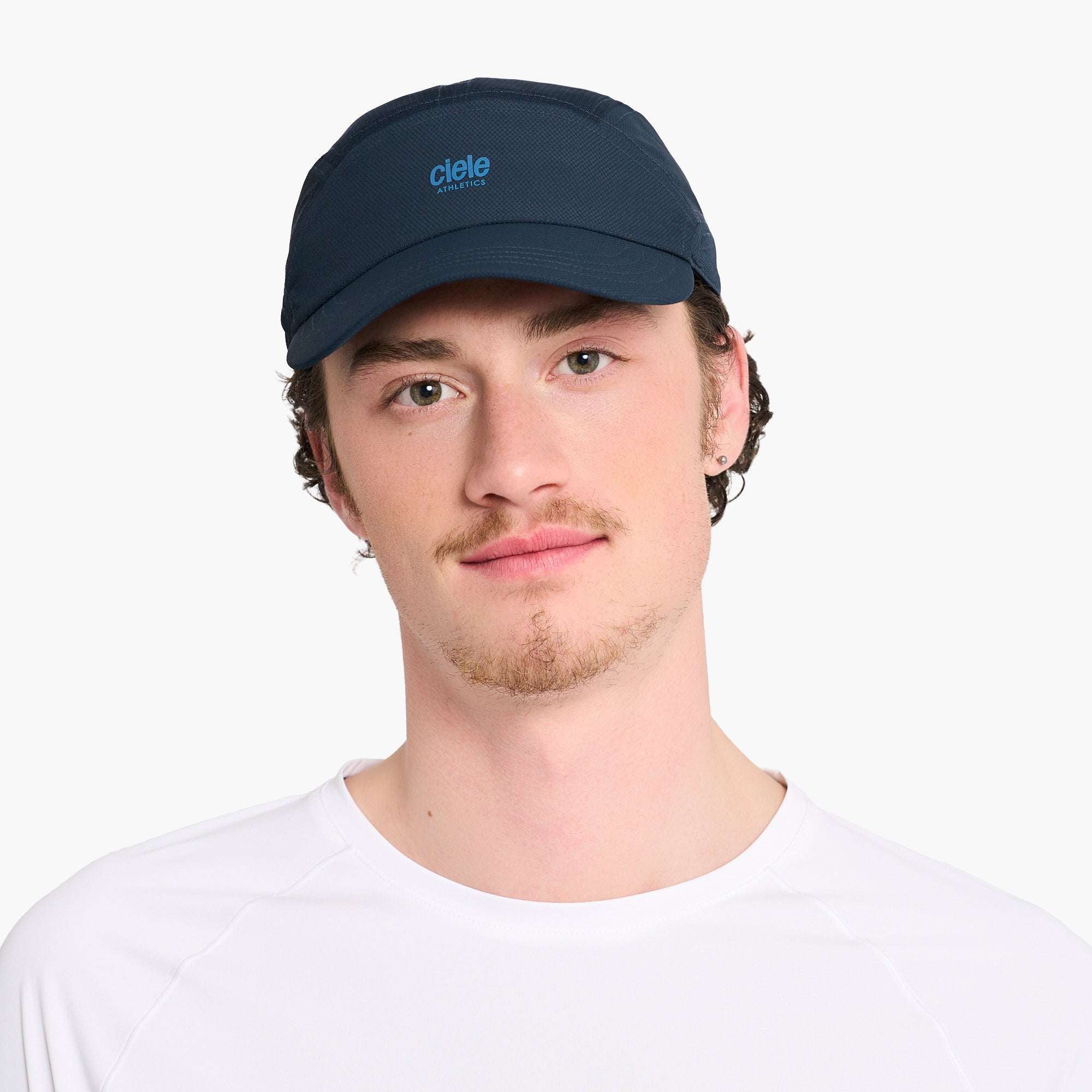 Ciele Dark navy running cap with Ciele logo, worn by a man