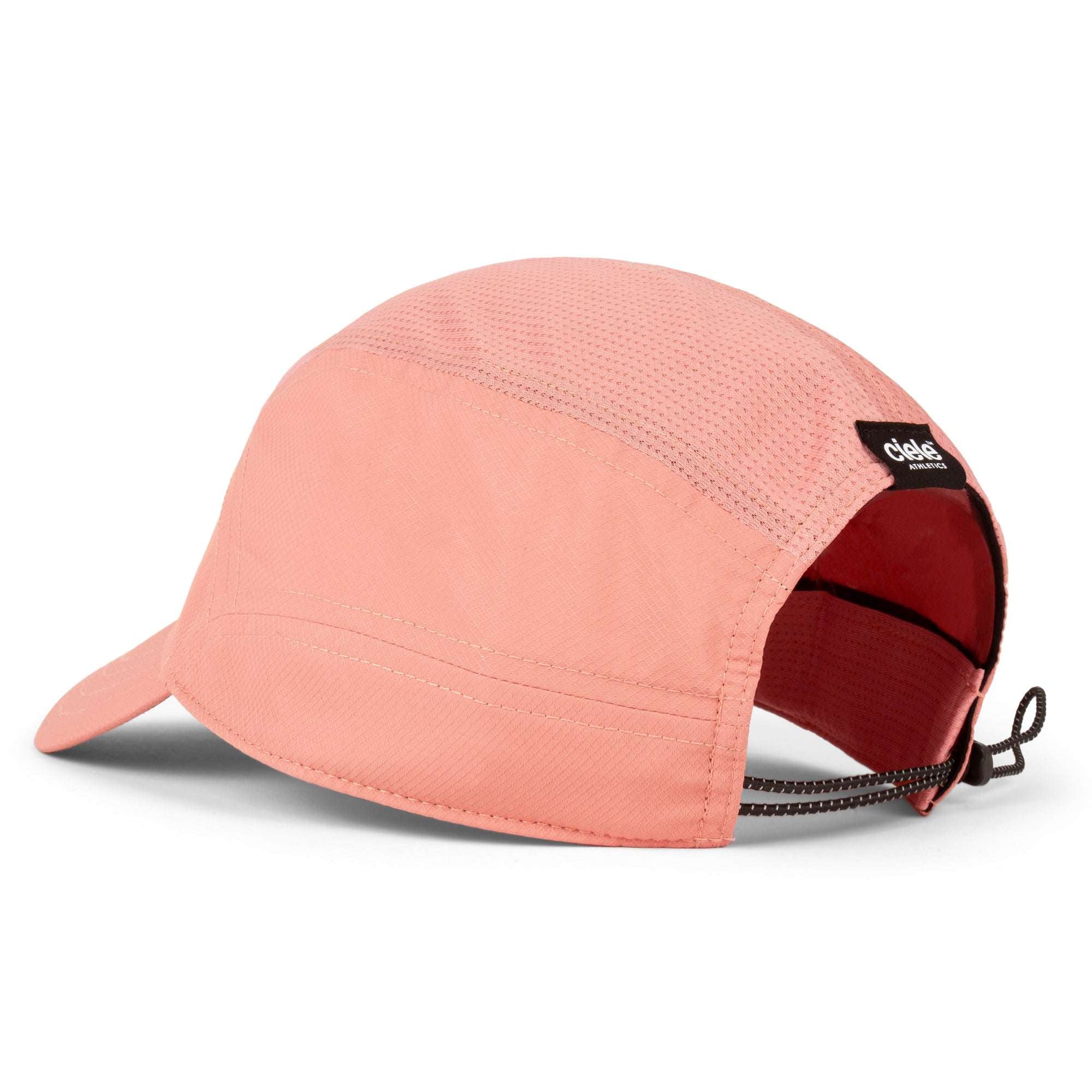 Peach-pink Ciele Athletics cap with curved brim, mesh texture, black logo patch
