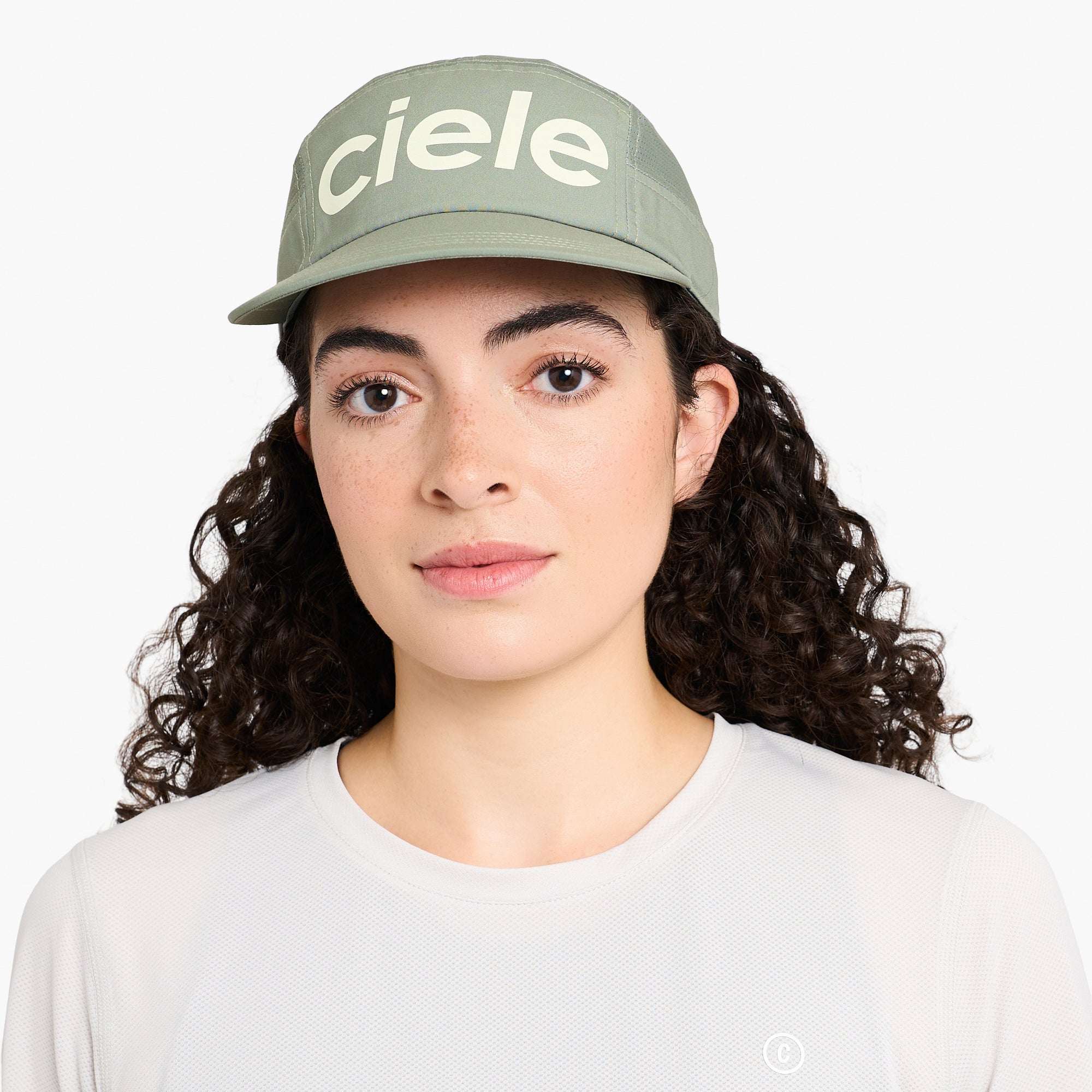 Ciele Sage green cap worn by model with ciele logo on front