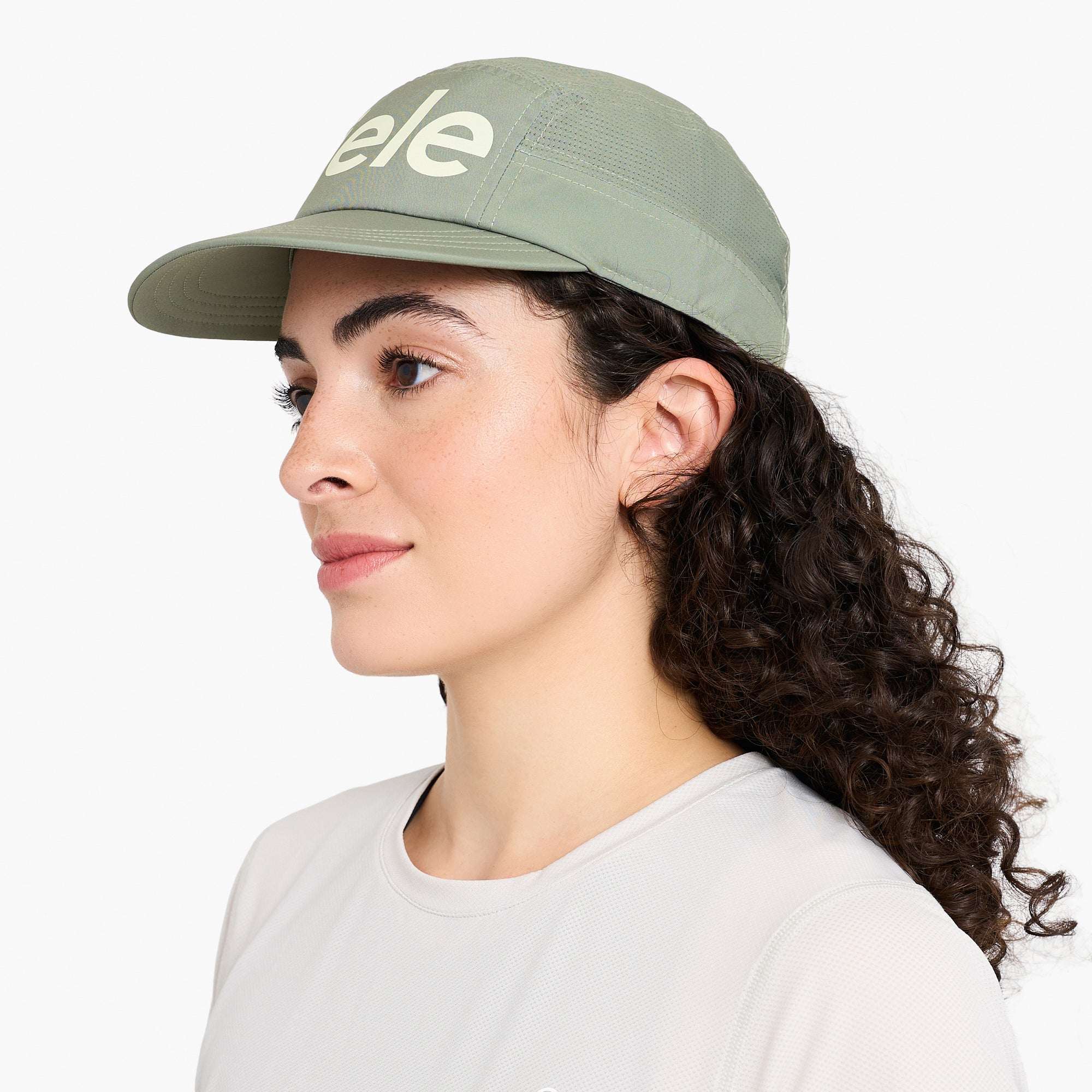 Ciele Sage green cap on model, side view with ciele logo and curved brim