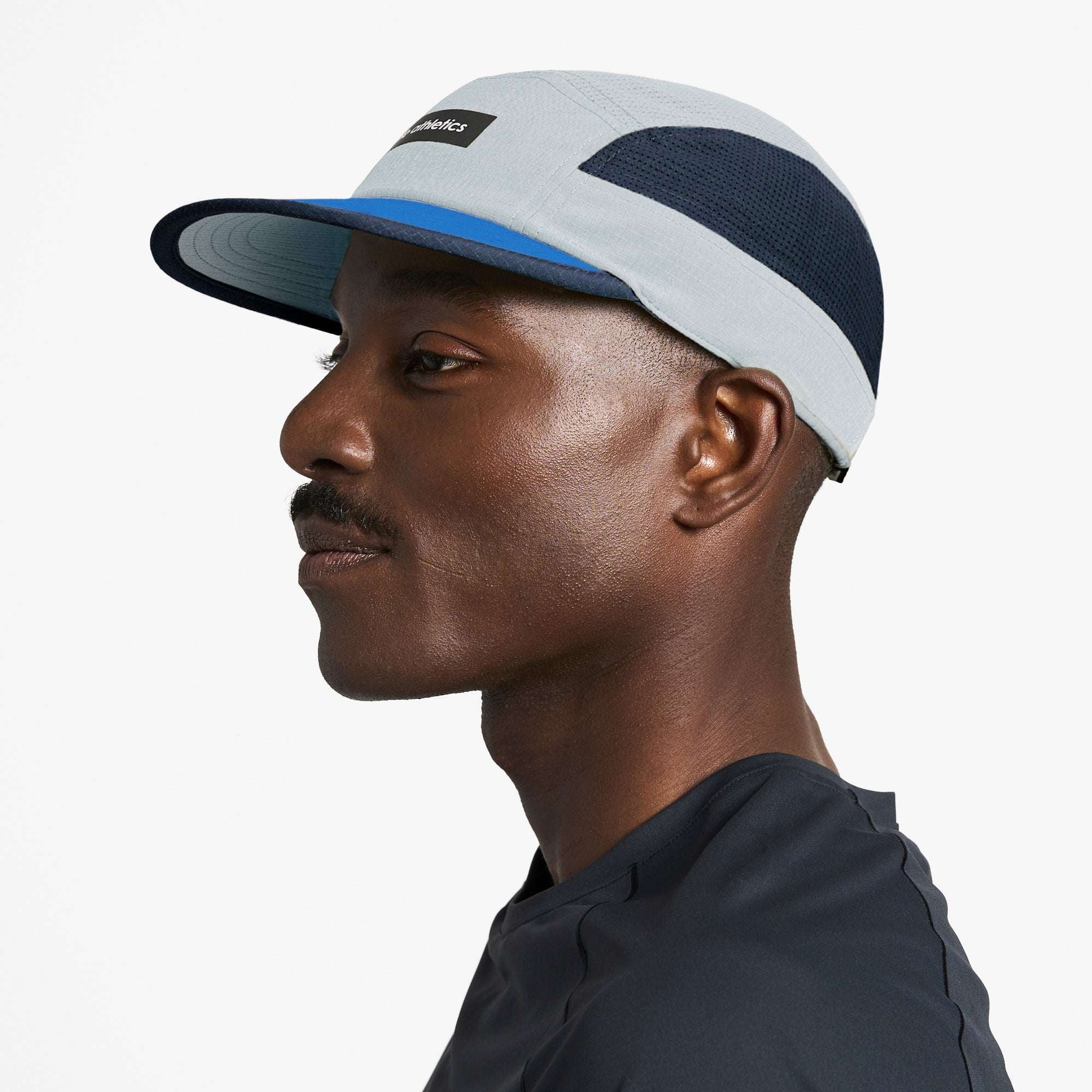 Ciele Athletics field cap with light gray panels, navy sides, and blue brim