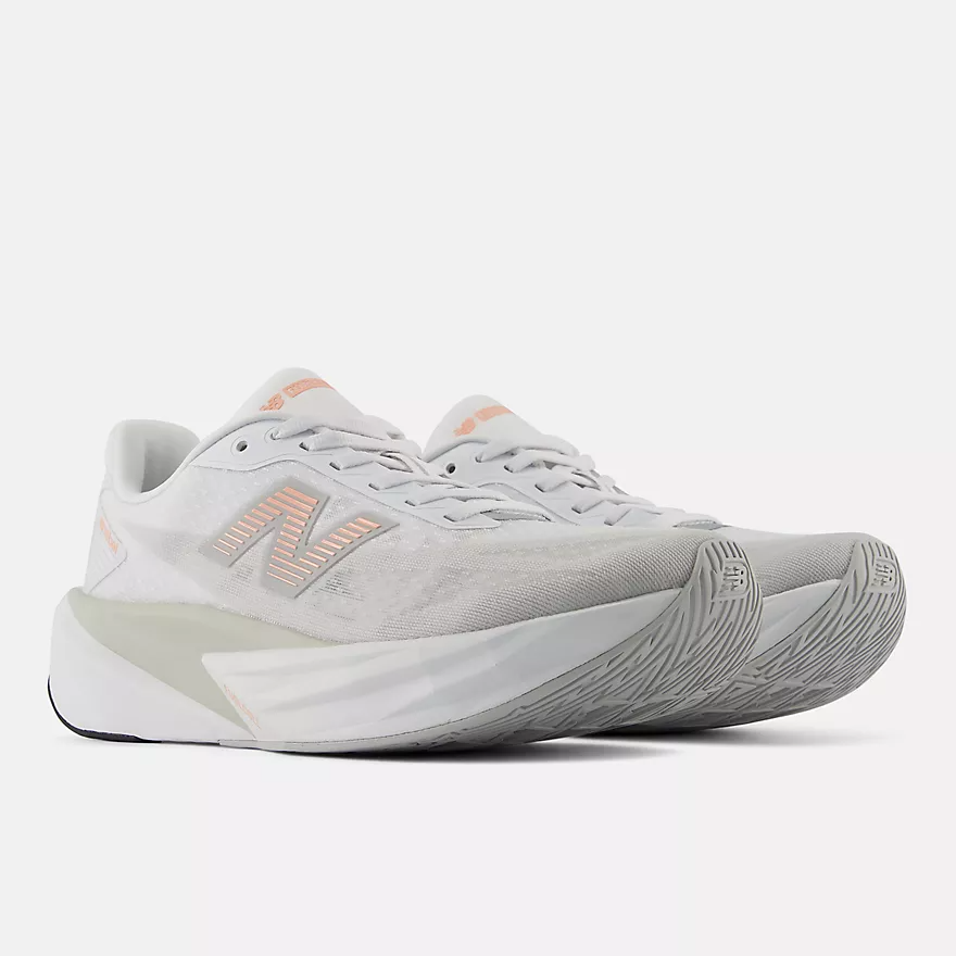 Women’s New Balance FuelCell Rebel v5 running shoe, 3/4 view with orange logo